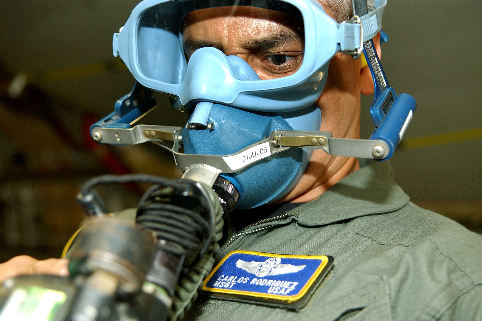 Master Sgt. Carlos Rodriguez tests his oxygen mask aboard a C-17 Globemaster III during Golden Medic 2006 on Saturday, June 17, 2006. The annual medical exercise involves medical servicemembers from various military branches, including the Air Force and Army this year. Sergeant Rodriguez is assigned to the 315th Aeromedical Evacuation Squadron at Robins Air Force Base, Ga. (U.S. Air Force photo/Staff Sgt. Stephen Schester)