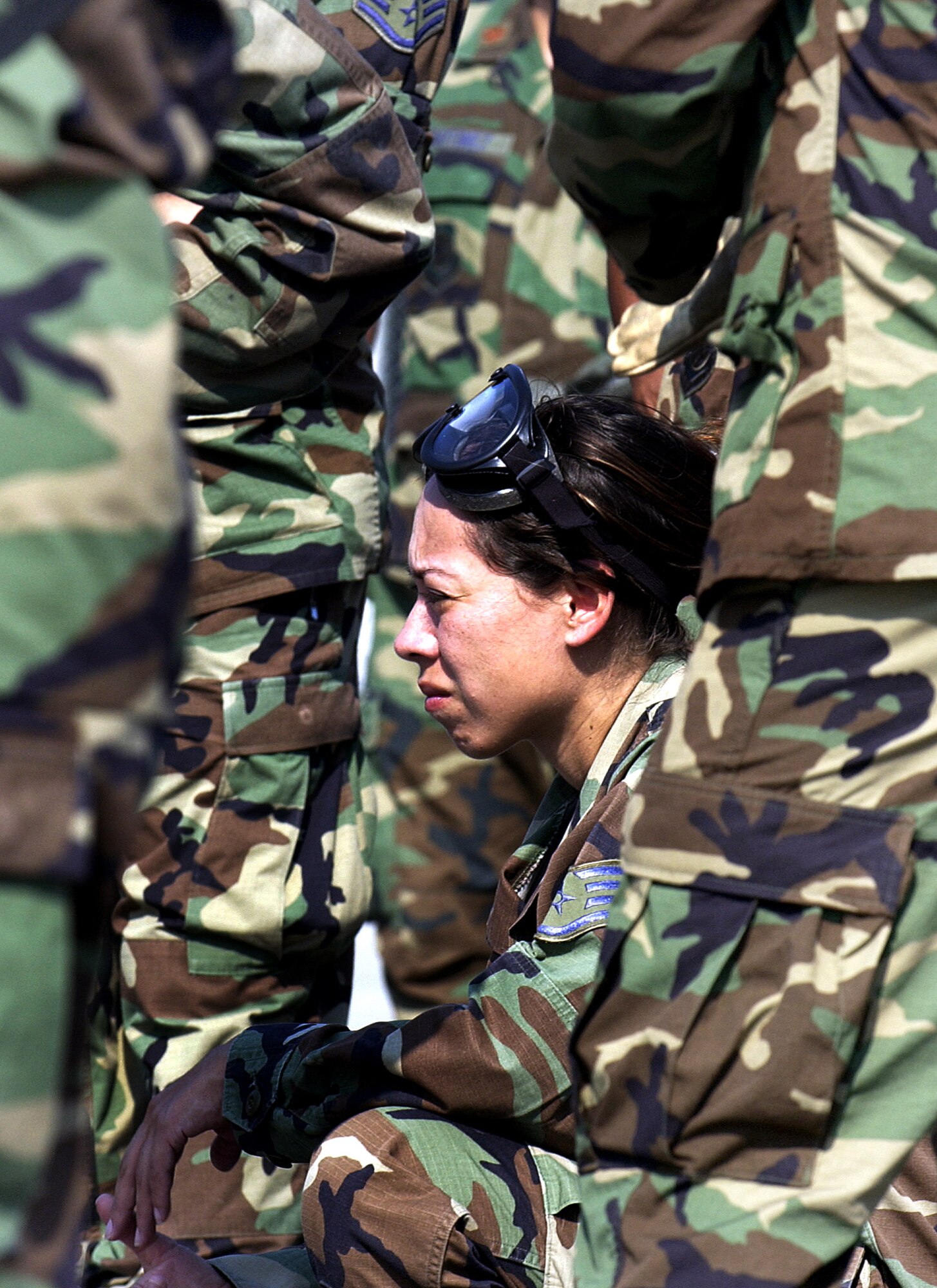 Staff Sgt. Christina Reyna kneels down to observe the loading and unloading of patients onto a C-130 Hercules at Augusta Regional Airport, Ga., on Thursday, June 15, as part of Golden Medic 2006. The annual medical exercise involves medical servicemembers from various military branches, including the Air Force and Army this year. Sergeant Reyna is assigned to the 433rd Aeromedical Evacuation Squadron at Lackland Air Force Base, Texas. (U.S. Air Force photo/Staff Sgt. Stephen Schester)
