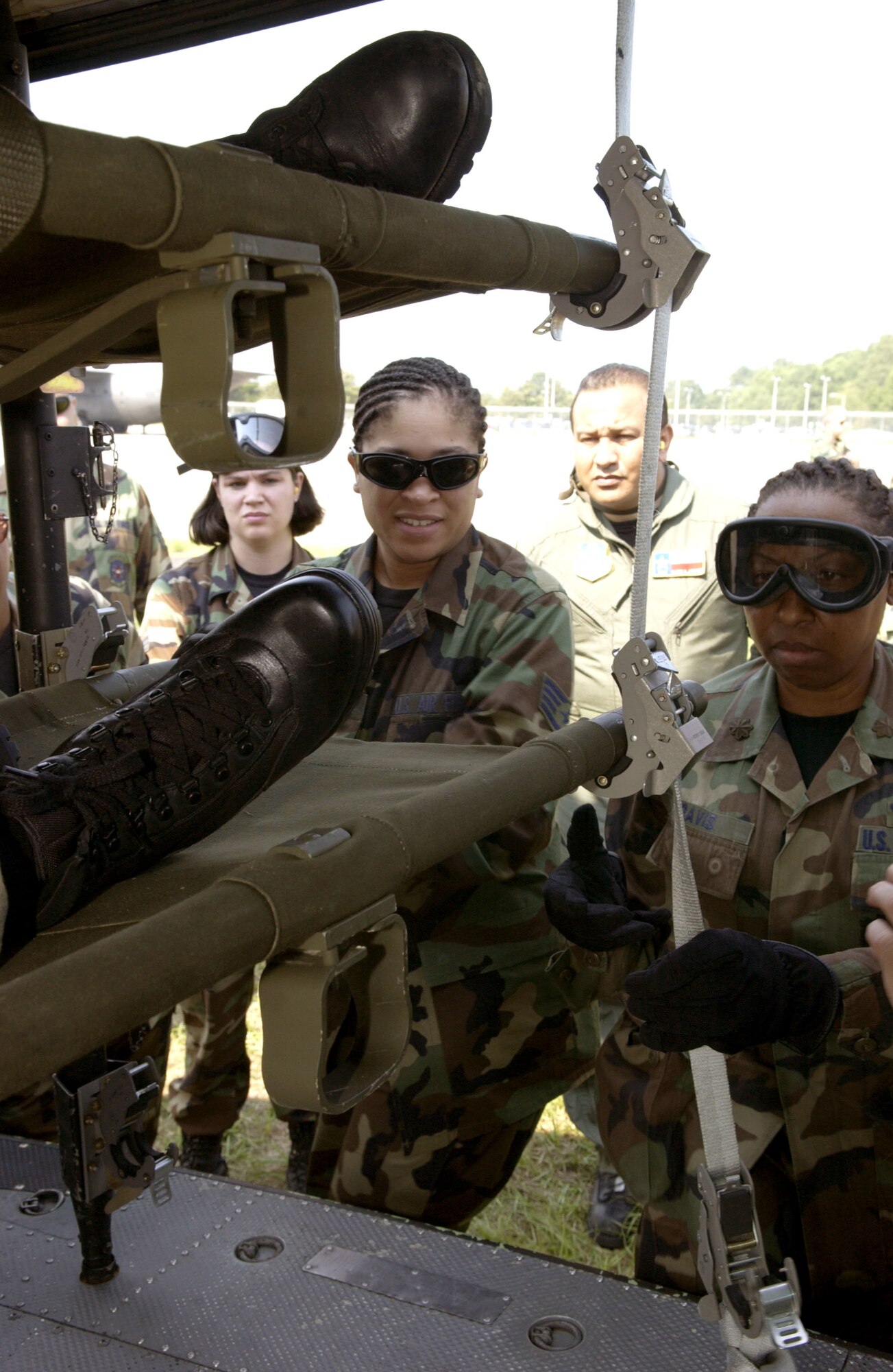 Air Force medical professionals train in the loading and unloading of patients to an Army UH-I Huey at Augusta Regional Airport, Ga., on Thursday, June 15, as part of Golden Medic 2006. The annual medical exercise involves medical servicemembers from various military branches, including the Air Force and Army this year. (U.S. Air Force photo/Senior Airman Jacqueline Kabluyen) 
