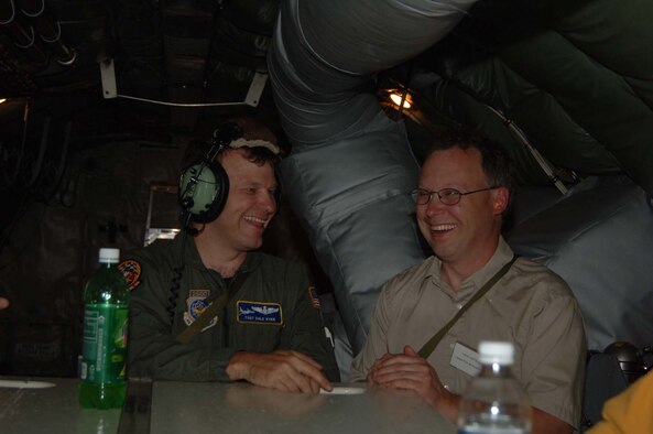 Tech. Sgt. Dale Ryan, 63rd Air Refueling Squadron boom operator, enjoys a good laugh with one of the clergy during a refueling orientation flight June 16. Forty-two members of the clergy participated in Clergy Day.