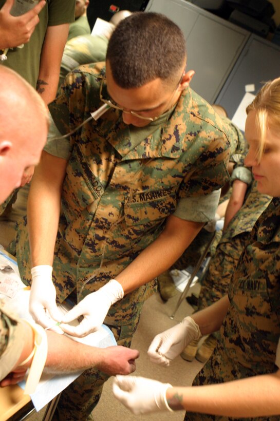 MARINE CORPS BASE CAMP LEJEUNE, N.C. ? Cpl. Yumeta A. Moldonado sticks a needle in a partner June 22. The combat lifesaver course is designed to train as many Marines as possible from 2nd Marine Logistics Group and ideally there will be one combat lifesaver to every 15 Marines. Moldonado is a motor transportation operator with Combat Logistics Regiment 2, 2nd MLG.
