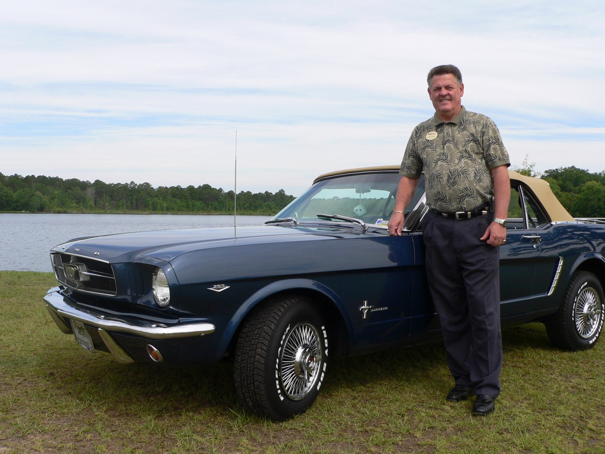 MOODY AIR FORCE BASE, Ga. -- Buddy Chapman, 347th Services Squadron here, shows off his 1965 Ford Mustang he bought after injuring himself during a rodeo in Germany and finding out he could no longer ride horses. Mr. Chapman, a retired chief master sergeant, has spent the last couple years rebuilding his classic car. (U.S. Air Force photo by Senior Airman S.I. Fielder)