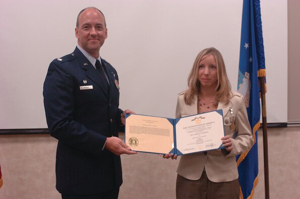 Ms. Robinson is awarded the Airman's Medal by Lt. Col. Greg Myers, 5th Air Support Operations Squadron commander, June 16 at Fort Stewart, Ga.  The 15th ASOS reports to U.S. Central Command Air Forces at Shaw.   (Courtesy photo)