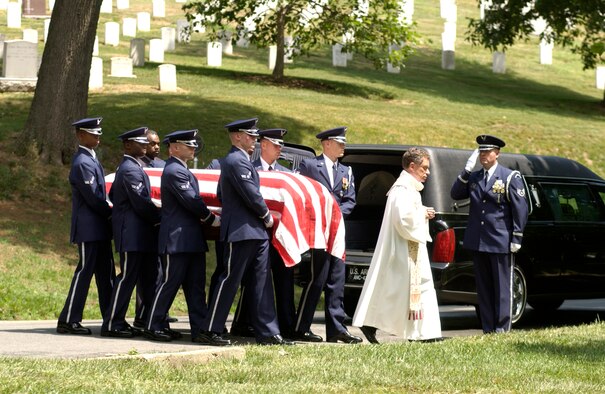 An Air Force Honor Guard detail and a chaplain proceed to the final resting place of Staff Sgt. Calvin Cooke Jr. at Arlington National Cemetery in Arlington, Va., on Tuesday, June 20. Sergeant Cooke, a C-130 Hercules loadmaster, died in April 1972 when his aircraft crashed in South Vietnam after being hit by ground fire. His remains were identified last month by experts at the Joint Prisoner of War/Missing in Action Accounting Command headquarters. (U.S. Air Force photo/Tech. Sgt. Cohen A. Young)