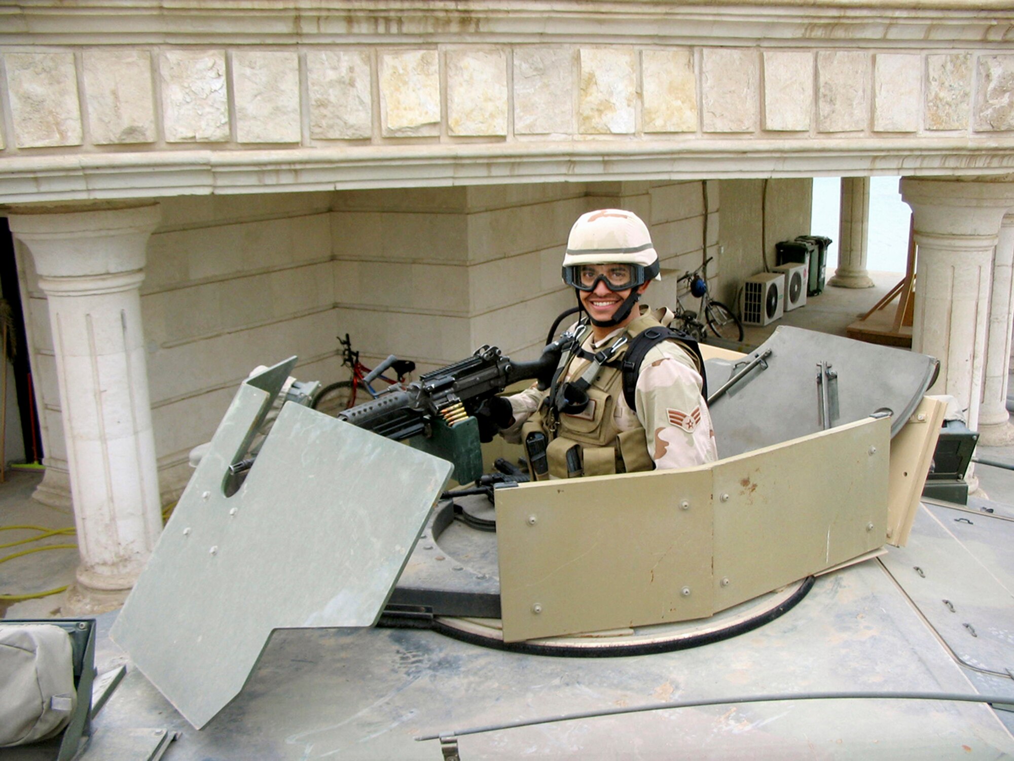 Senior Airman Eric J. Pena, from the 349th Air Mobility Wing, Travis Air Force Base, Calif., mans a turret gun during a convoy operation in Baghdad in February 2005. An Air Force reservist, Airman Pena was selected as one of the Air Force's 12 Outstanding Airmen of the Year. (U.S. Air Force photo)