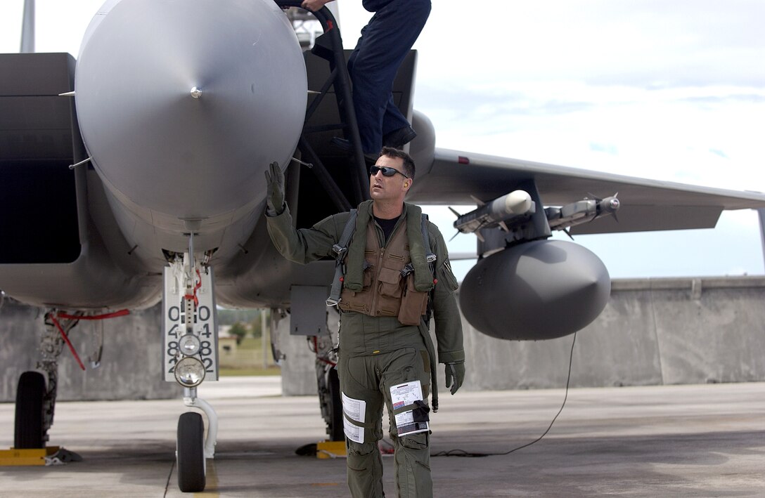 Maj. Paul Johnson performs a pre-flight inspection on an F-15 Eagle before a training sortie at Andersen Air Force Base, Guam, on Thursday, June 22, for Valiant Shield 2006. The exercise, which concludes June 23, focuses on integrated joint training in a variety of mission scenarios. Major Johnson is assigned to the 44th Fighter Squadron at Kadena Air Base, Japan. (U.S. Air Force photo/Airman 1st Class Michael S. Dorus) 