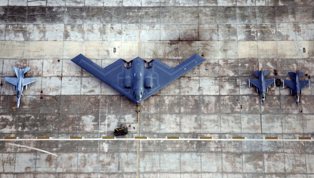 A B-2 Spirit, two F-16 Fighting Falcons and an F-18 Hornet sit on the flightline at Andersen Air Force Base, Guam, for Exercise Valiant Shield on Thursday, June 22. The exercise, which concludes June 23, focuses on integrated joint training in a variety of mission scenarios. (U.S. Air Force photo/Staff Sgt. Bennie J. Davis III)