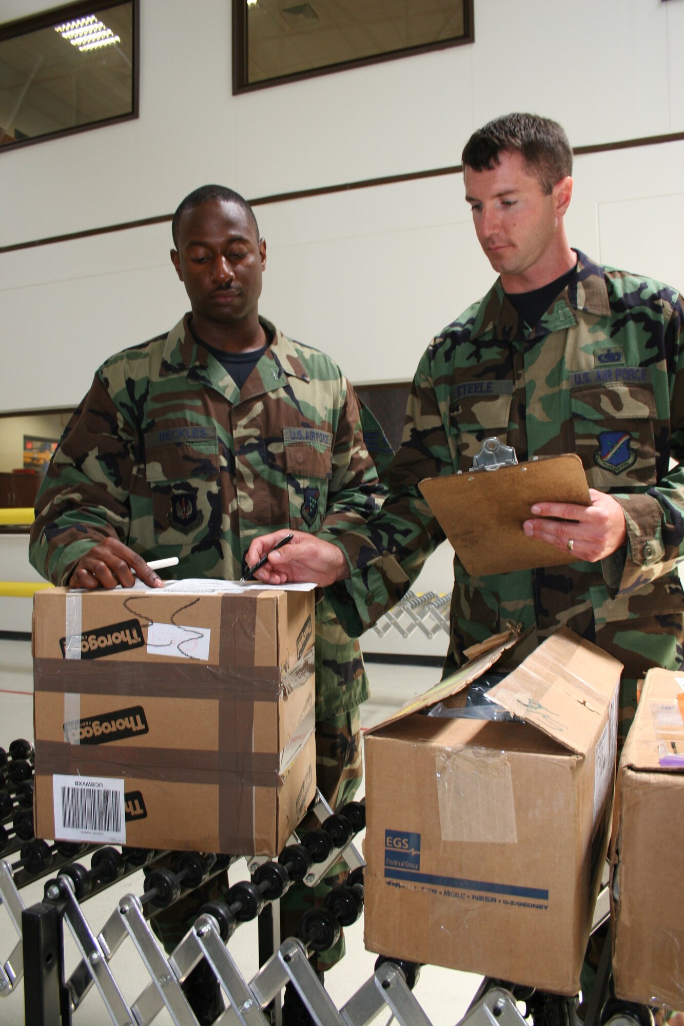 INCIRLIK AIR BASE, Turkey -- Staff Sgt. Raja Beckles (left), 39th Logisitics Readiness Squadron material management flight NCOIC of outbound cargo, and Tech. Sgt. Chad Steele, 39th LRS material management flight NCOIC of storage and issues and hazardous materials, inventory boxes in Building 252 June 21. (Photo by Staff Sgt. Oshawn Jefferson)