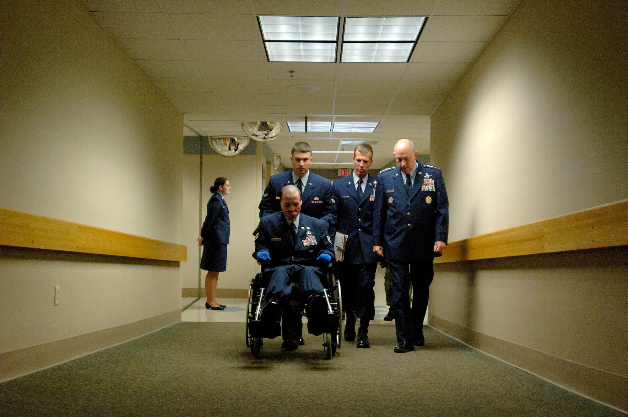 Staff Sgt. Israel del Toro and Air Force Chief of Staff T. Michael Moseley are escorted to the Brooke Army Medical Center auditorium before the presentation of the Purple Heart Medal today at Fort Sam Houston, Texas.  Sergeant del Toro was wounded during combat action in Afghanistan in December 2005 while supporting Operation Enduring Freedom.  (U. S. Air Force photo/Tech. Sgt. Cecilio M. Ricardo)