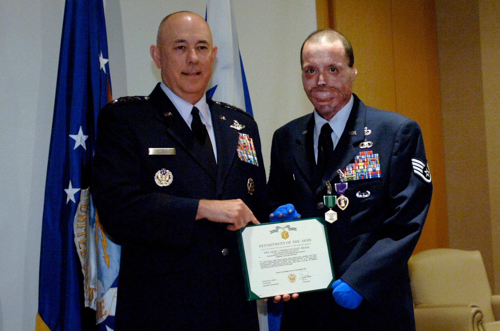 Staff Sgt. Israel del Toro receives the Purple Heart Medal from Air Force Chief of Staff Gen. T. Michael Moseley today at Fort Sam Houston, Texas.  Sergeant del Toro was wounded during combat action in Afghanistan in December 2005 while supporting Operation Enduring Freedom.  (U. S. Air Force photo/Tech. Sgt. Cecilio M. Ricardo)