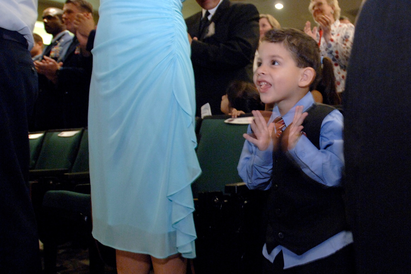 Israel del Toro Jr. applauds his father, Staff Sgt. Israel del Toro, during the presentation of the Purple Heart Medal by Air Force Chief of Staff Gen. T. Michael Moseley today at Fort Sam Houston, Texas.  Sergeant del Toro was wounded during combat action in Afghanistan in December 2005 while supporting Operation Enduring Freedom.  (U. S. Air Force photo/Tech. Sgt. Cecilio M. Ricardo)