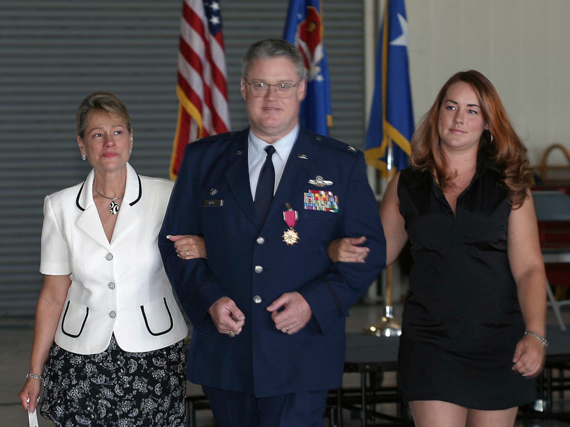 Col. James Kerr, 940th Air Refueling Wing commander, escorts his wife, Nancy, and daughter, Lisa Vanderbrug, after his wing relinquish of command ceremony June 10, 2006 at Beale Air Force Base, Calif.  Colonel Kerr is transferring to McGuire AFB, N.J. to be the commander of the 514th Air Mobility Wing. (U.S. Air Force/courtesy photo) 