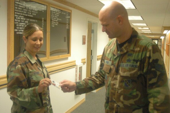 Staff Sgt. John Cooper, 7th Bomb Wing
Protocol, checks the ID of Airman 1st
Class Jennifer Stone's, 7th Comptroller
Squadron, during a random anti-terrorism
measure check Tuesday. It?s everyone?s
job to stay vigilant during RAMs.                                