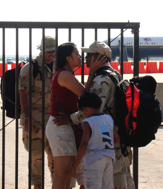 Families say tearful goodbyes to deploying servicemembers outside the Wash Rack before members of the 317th Airlift Group deploy June 15 in support of Operations Iraqi and Enduring Freedom and joint task forces in the Horn of Africa.