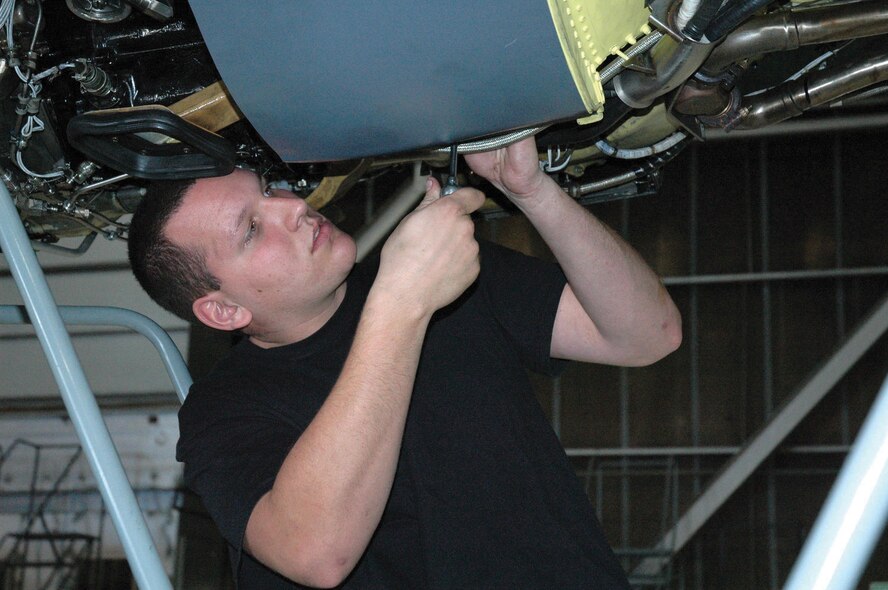 MINOT AIR FORCE BASE, N.D. --- Airman 1st Class Donald Ridley, 5th Maintenance Squadron jet engine mechanic, tightens down bolts on an engine of a B-52H Stratofortress during a phase inspection at the Phase Dock. (Photo by Airman 1st Class Ross Tweten) 