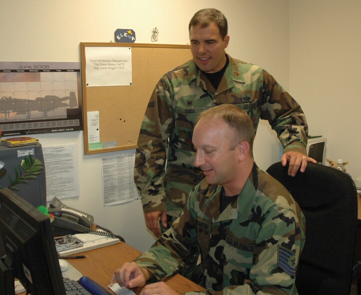 MINOT AIR FORCE, N.D. -- Maj. Joseph Ogea, 5th Mission Support Squadron commander, and Tech. Sgt. Gordon Martin, 5th MSS, update Major Ogea’s records in the 5th MSS orderly room Tuesday. Major Ogea  assumed his new command June 20, 2006.  (U.S. Air Force photo by Senior Airman Danny Monahan)
