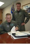 MINOT AIR FORCE, N.D. -- Lt. Col. Jed Davis, 741st Missile Squadron commander, looks over a Netlink manual with Capt. Corey Harvey, 741st MS, at the 91st Space Wing headquarters Wednesday. Colonel Davis assumed his new command June 20, 2006. (U.S. Air Force photo by  Airman Joe Rivera)                           