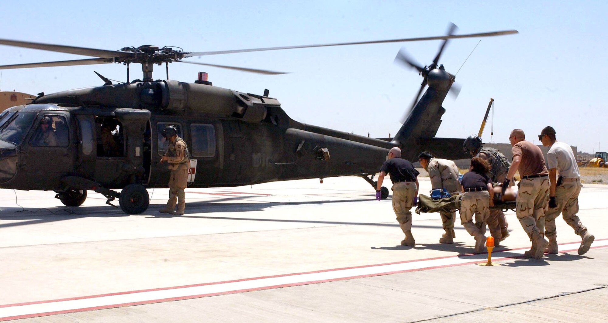 Airmen with the 506th Expeditionary Medical Group at Kirkuk Air Base, Iraq, load an injured patient on an Army UH-60 Black Hawk for medical evacuation on Wednesday, June 21. (U.S. Air Force photo/Senior Airman Angelita M. Collins) 
