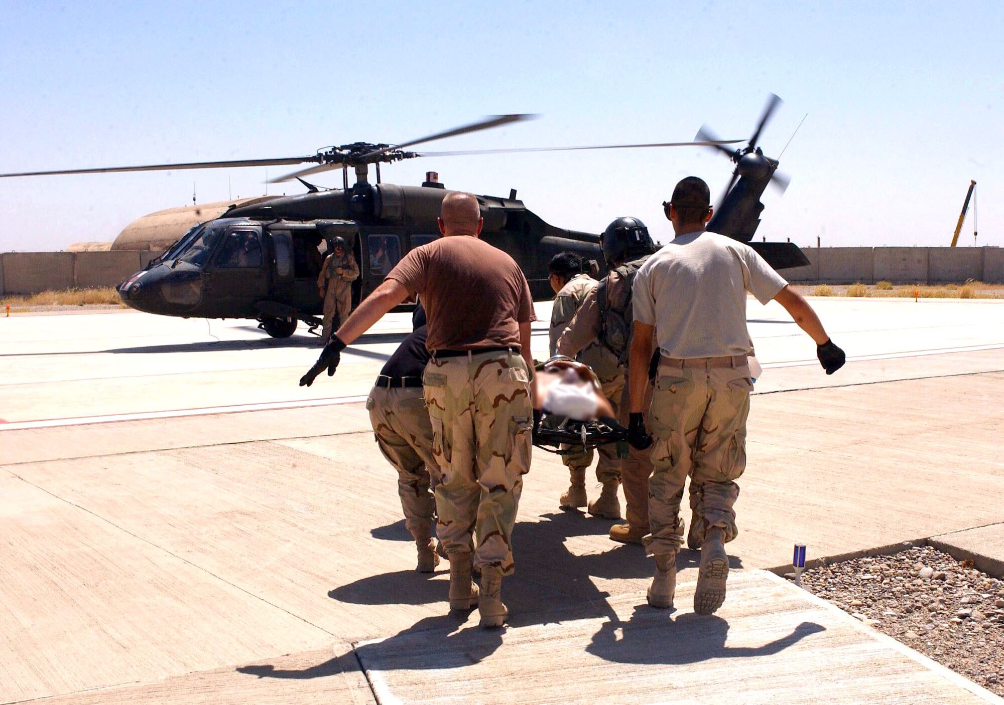 Airmen with the 506th Expeditionary Medical Group at Kirkuk Air Base, Iraq, load an injured patient on an Army UH-60 Black Hawk for medical evacuation on Wednesday, June 21. (U.S. Air Force photo/Senior Airman Angelita M. Collins) 


