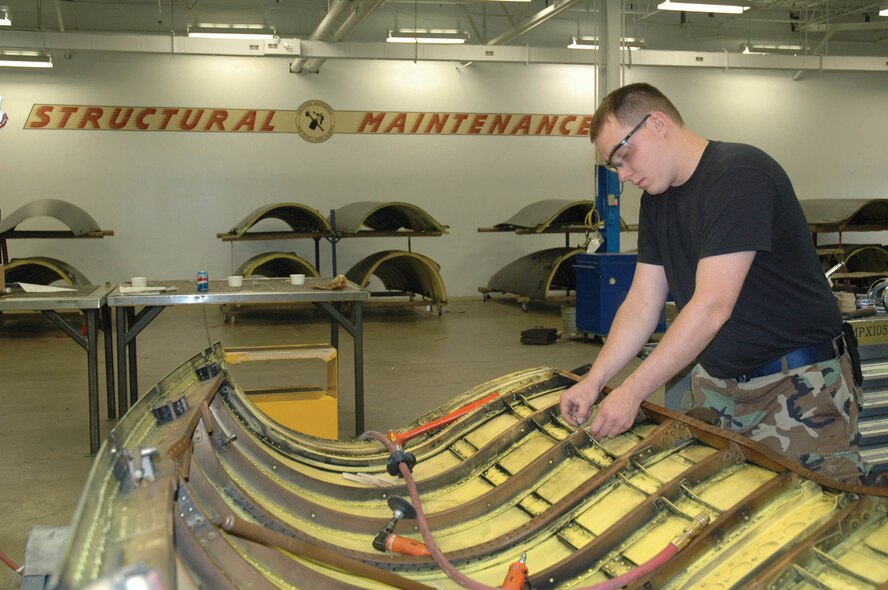 MINOT AIR FORCE BASE, N.D. -- Senior Airman Adam Johnson, 5th Maintenance Squadron Structural Maintenance/Corrosion Control  shop, installs a bracket on an upper-body cowling of a B-52H Stratofortress at the structural maintenance bay June 12, 2006. (U.S. Air Force photo by Airman 1st Class Ross Tweten)