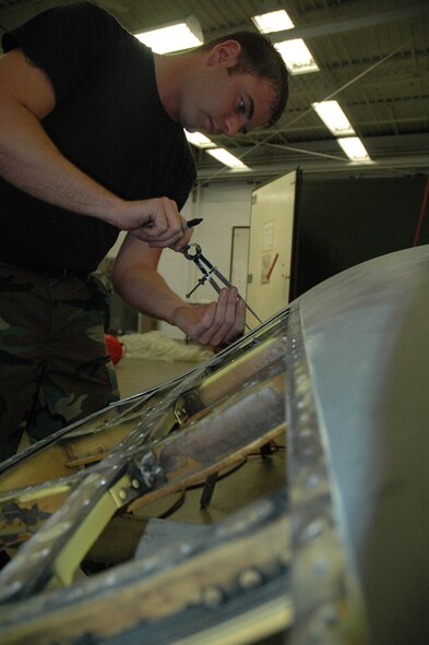 MINOT AIR FORCE BASE, N.D. -- Senior Airman Nicholas Gauthier, 5th Maintenance Squadron Structural Maintenance/Corrosion Control shop, lays-out a rivet pattern on an upper-body cowling of a B-52H Stratofortress at the structural maintenance bay June 12, 2006. (U.S. Air Force photo by Airman 1st Class Ross Tweten)