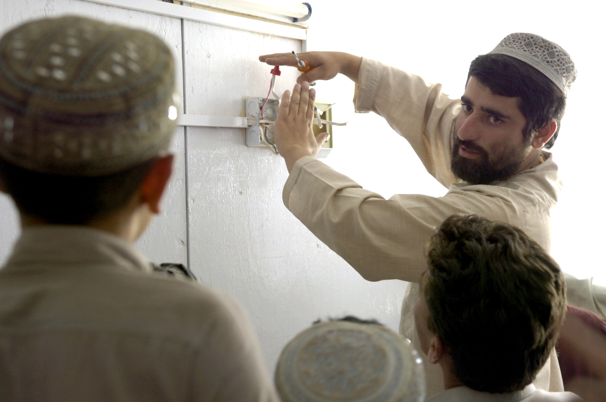 Saeed explains the components of an electrical box to Afghan students at the Qalat Provincial Reconstruction Team's Trade School on Monday, June 12. The instructors teach local Afghans skills they can use to get jobs and help rebuild their country. Saeed is a former plumbing and carpentry trade school student who returned eight months ago to teach at the school. (U.S. Air Force photo/Senior Airman Brian Ferguson) 
