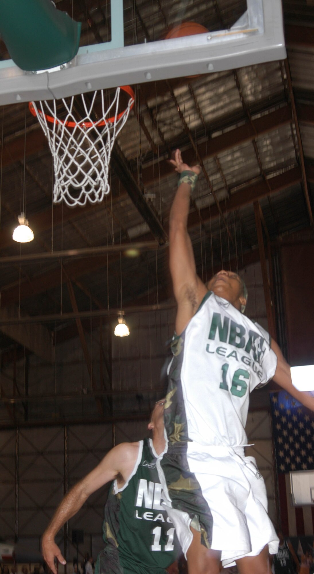 EDWARDS AIR FORCE BASE, Calif. — Actor Corey Hardrict, from the movie "Crazy/Beautiful," does a layup during the National Basketball Association Entertainment League game here June 17. Mr. Hardrict represented the 95th Air Base Wing Strikers team. Striker team defeated the 412th Test Wing Fighter team, 88-77. (Air Force photo by Airman Stacy Garcia)

