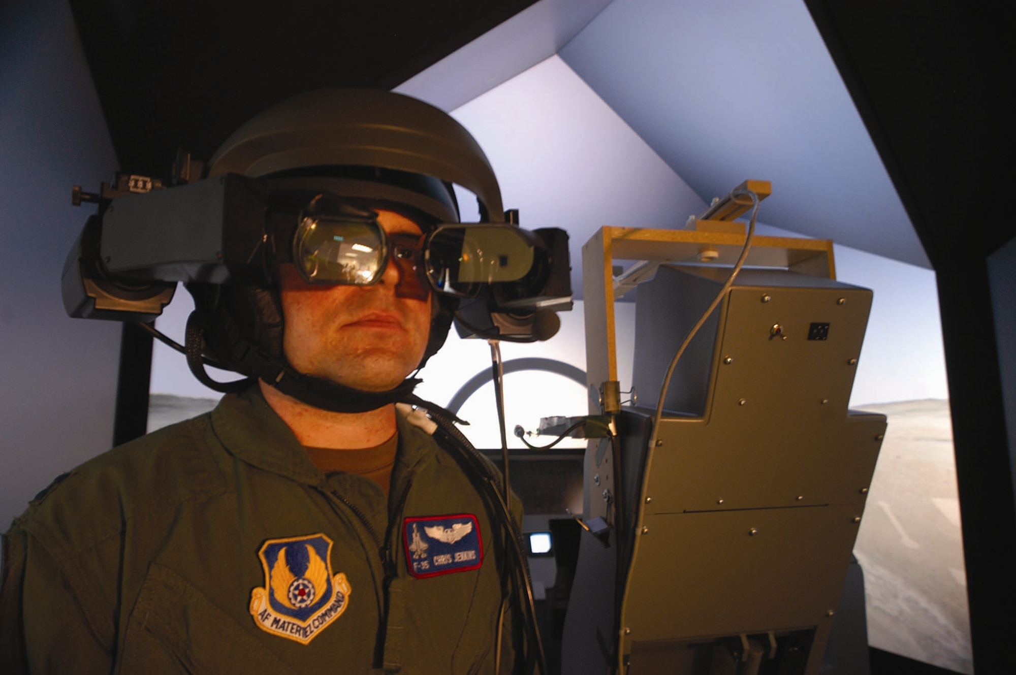 EDWARDS AIR FORCE BASE, Calif. — Capt. Chris Jenkins, Pilot Vehicle Interface lead for the F-35 Joint Strike Fighter Program Integrated Test Force, tries on the commercially available helmet-mounted display his team adapted for use with the JSF simulator. The team used the helmet for risk-reduction studies, which were completed June 20. (Air Force photo by Christopher Ball)

