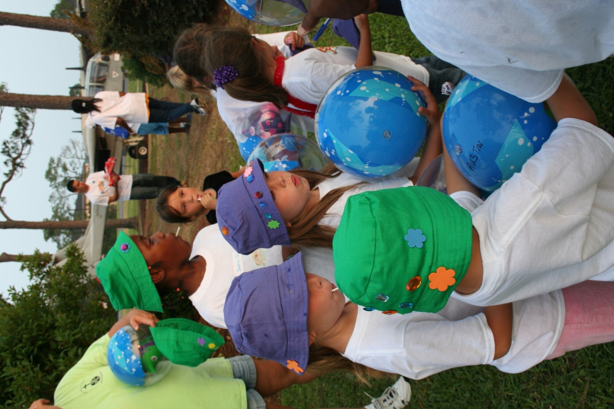 After participating in a treasure hunt led by a swashbuckling pirate, the three- and four-year-olds take the opportunity to mingle with the older children, who are passing out balls and suckers.