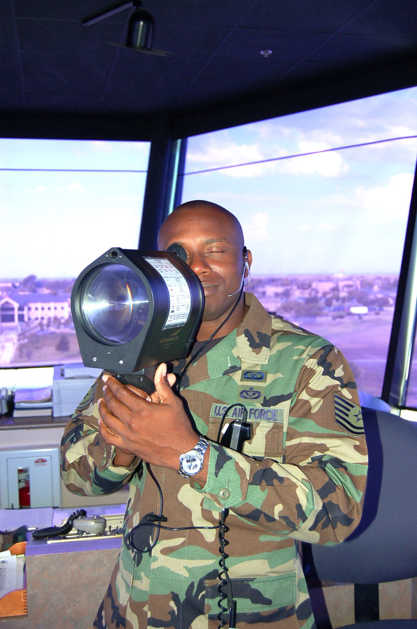 Tech. Sgt. Rond Sampson uses a light gun to signal aircraft crossing the runway at Laughlin Air Force Base, Texas, on June 26, 2006. Sergeant Sampson, from New York City, is an air traffic controller with the 47th Operations Support Squadron. (U.S. Air Force photo/Staff Sgt. Jeremy Larlee)