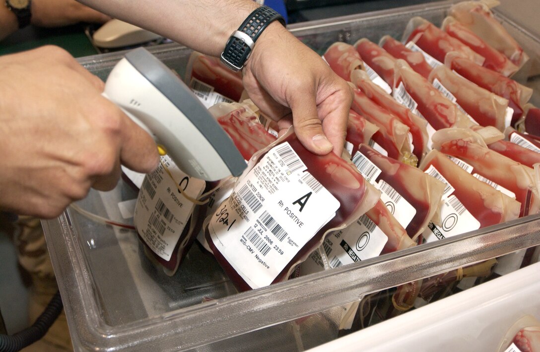 Master Sgt. Ed Juraszek scans in the bar code information on a unit of blood at the 379th Expeditionary Medical Group's Expeditionary Blood Transshipment System, or EBTS, in Southwest Asia. The center staff receives, inventories and redistributes between 1,200 and 1,800 units of blood and fresh frozen plasma each week to forward operating bases. (U.S. Air Force photo/Tech. Sgt. Chuck Marsh)