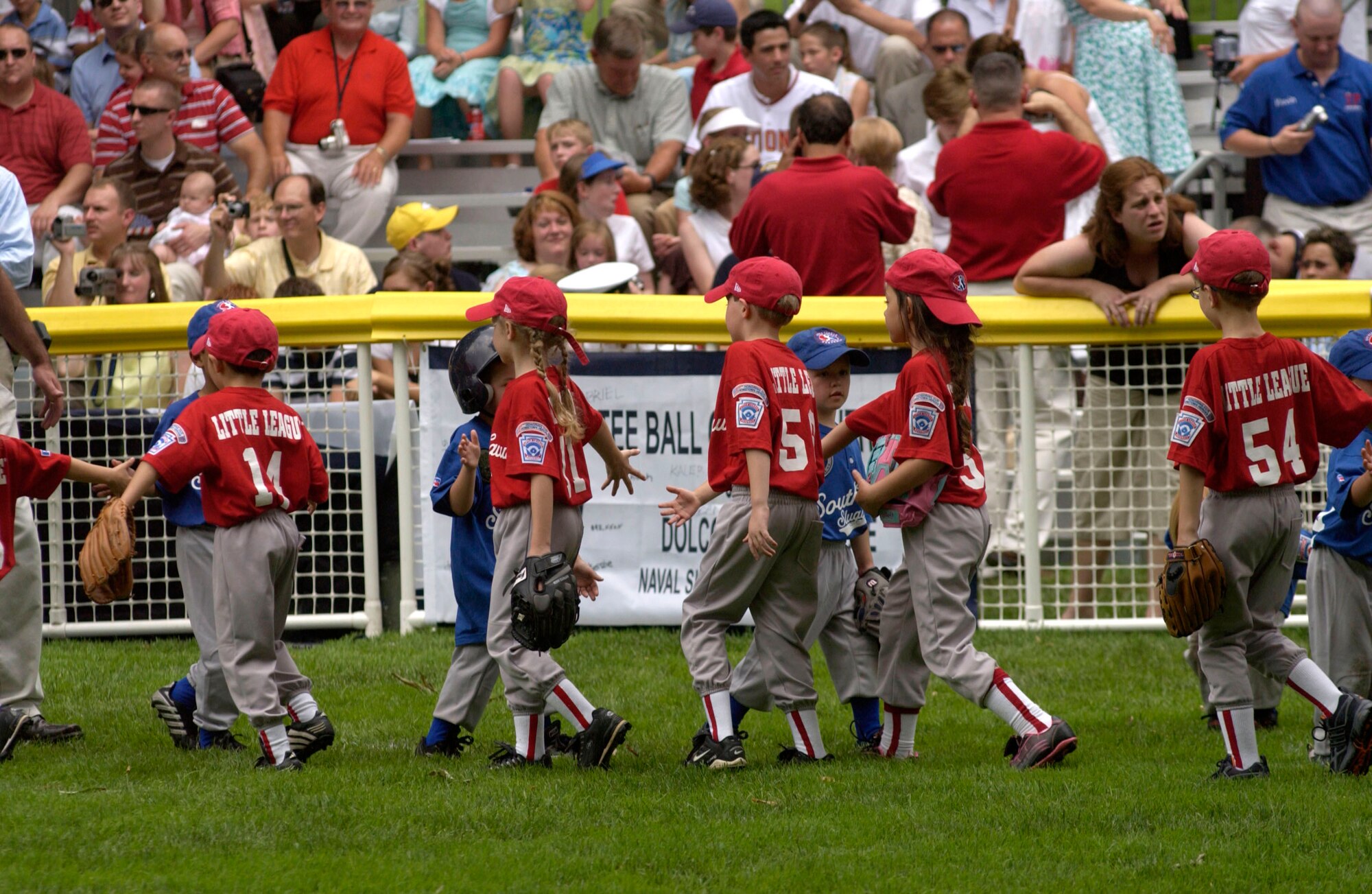 The Little League Yankees, in red, of McGuire Air Force Base, N.J., shake hands with the Dolcom Little League Indians of Naval Submarine Base New London, Groton, Conn., at the conclusion of their game on Friday, June 23. The game, marking the official start of the Little League season, was played on the South Lawn of the White House with President George W. Bush reciting the Little League Pledge with the teams. The two teams were randomly picked for this annual event. (U.S. Air Force photo/Tech. Sgt. Cohen A. Young) 