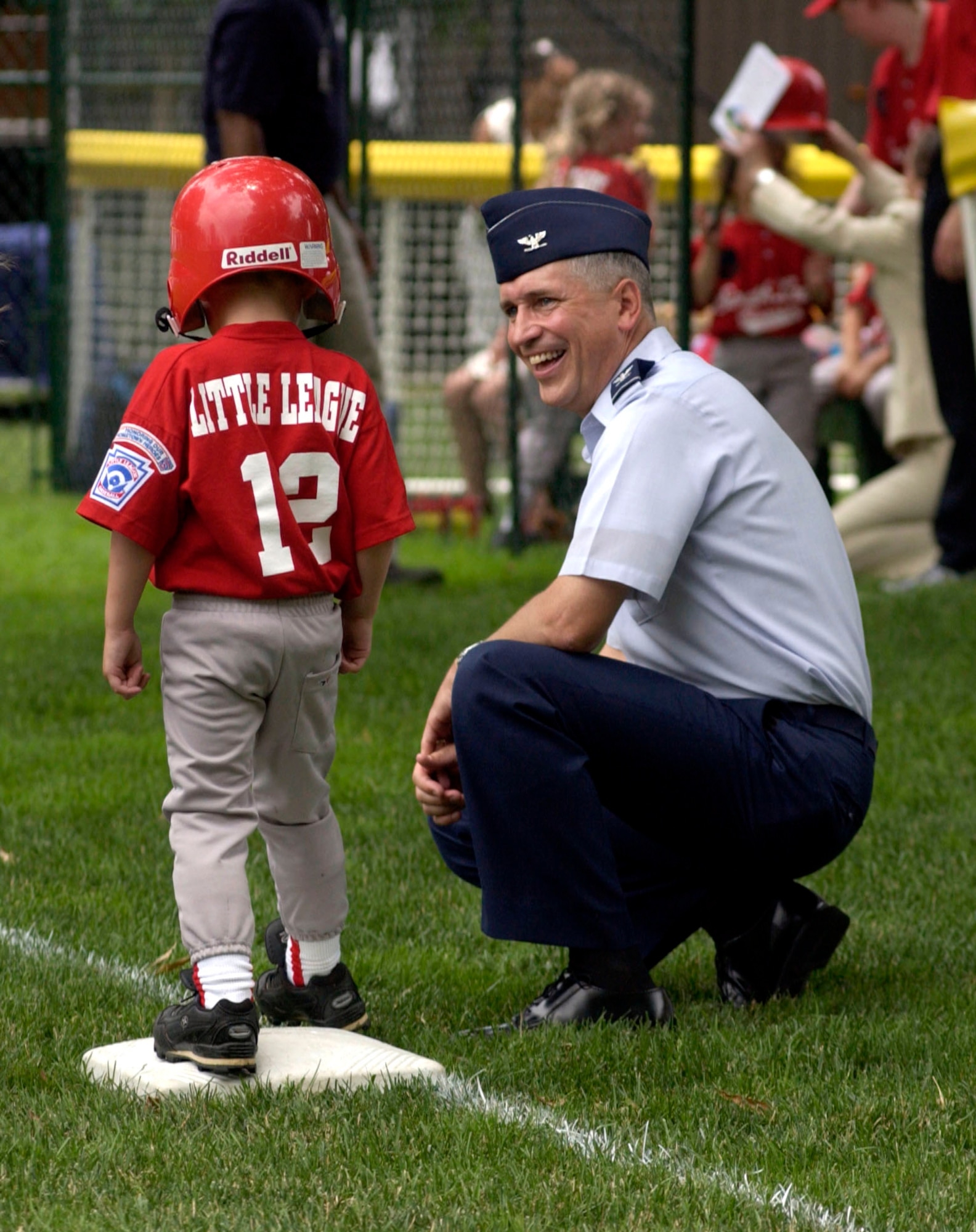 Col. Frederick Martin talks with 4-year-old Alex McPeak at third base during a game on the South Lawn of the White House on Friday, June 23, that marks the official start of the Little League Season.  Alex's mother, Danielle, is the coach of the Yankees team from McGuire Air Force Base, N.J. His father, Master Sgt. Todd McPeak, is deployed. Colonel Martin, assigned at McGuire, served as the third base coach for both the McGuire team and the Dolcom Little League Indians from Naval Submarine Base New London in Groton, Conn. (U.S. Air Force photo/Tech. Sgt. Cohen A. Young) 