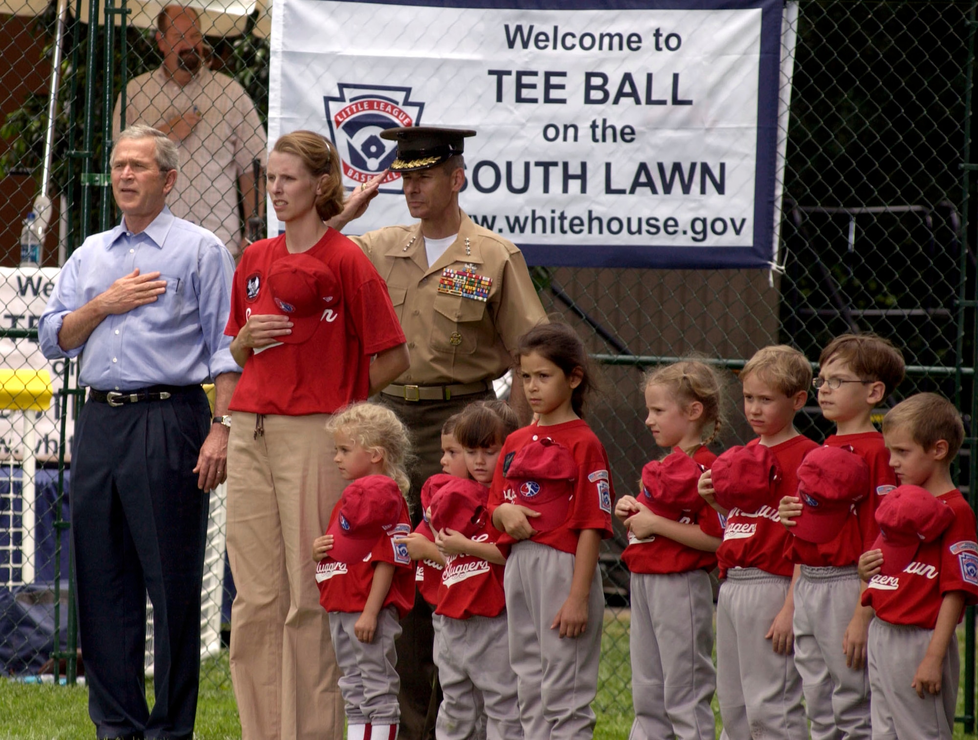 President George W. Bush, Danielle McPeak, Gen. Peter Pace, chairman of the Joint Chiefs of Staff and the Yankees Little League team from McGuire Air Force Base, N.J., stand during the National Anthem on the South Lawn of the White House on Friday, June 23. The ceremony marked the official start of the Little League season. Ms. McPeak is manager of the McGuire team. (U.S. Air Force photo/Tech. Sgt. Cohen A. Young)