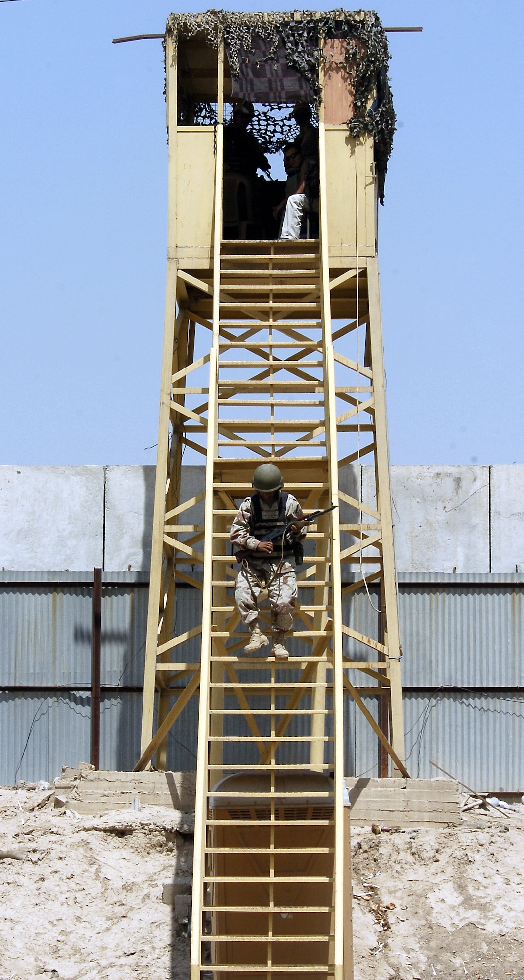 An Iraqi soldier is relieved from his tower at Camp Rustamiyah, Iraq, on Thursday, June 22. The soldier is with the base defense battalion preparing to take over security for the camp, which houses NATO forces and the Iraqi Military Academy. (U.S. Air Force photo/Senior Airman Brian Ferguson)

