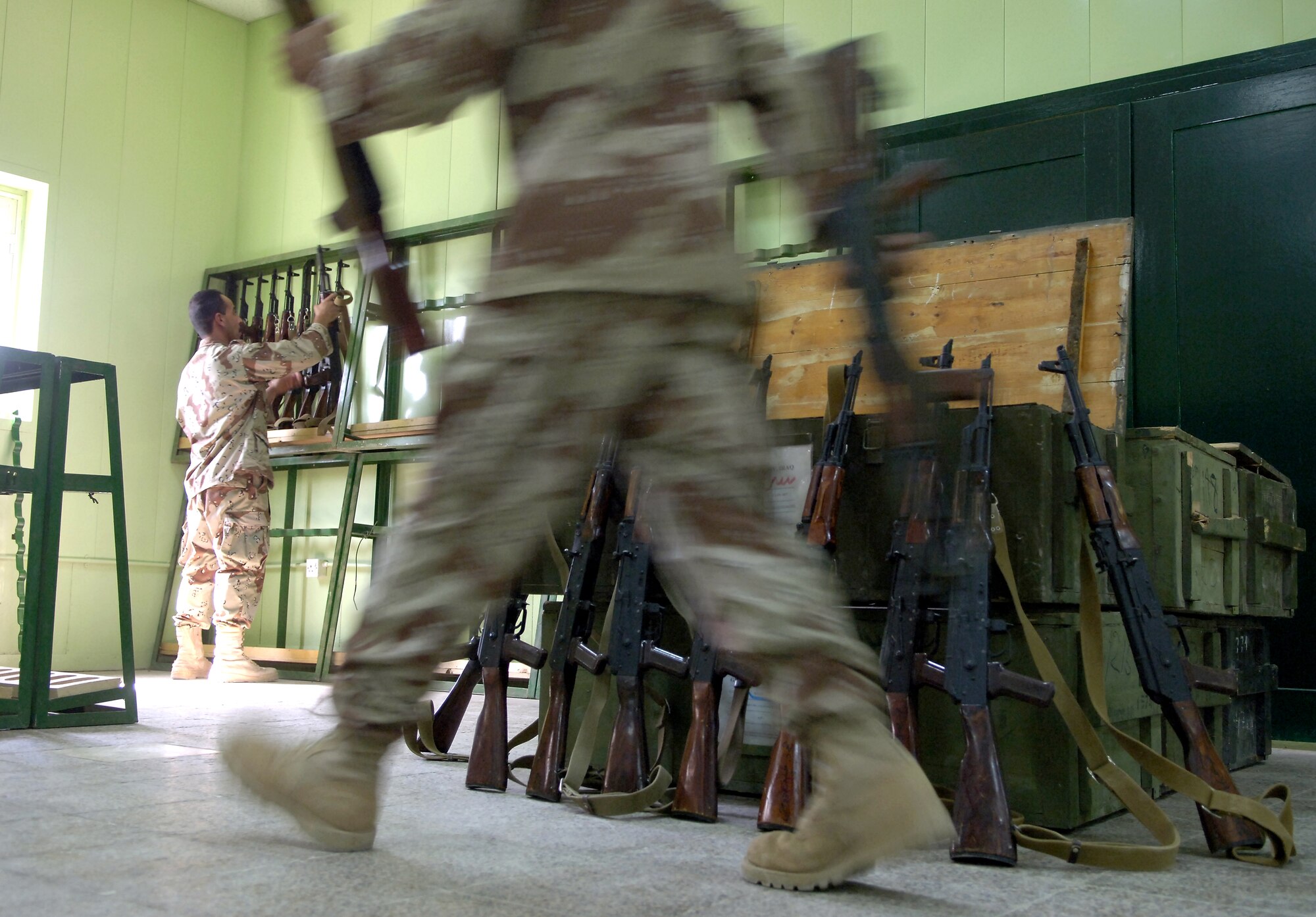Iraqi soldiers unload a crate of AK-47s at their new armory at Camp Rustamiyah, Iraq, on Wednesday, June 21. The soldiers are with the base defense battalion preparing to take over security for the camp, which houses NATO forces and the Iraqi Military Academy. (U.S. Air Force photo/Senior Airman Brian Ferguson)

