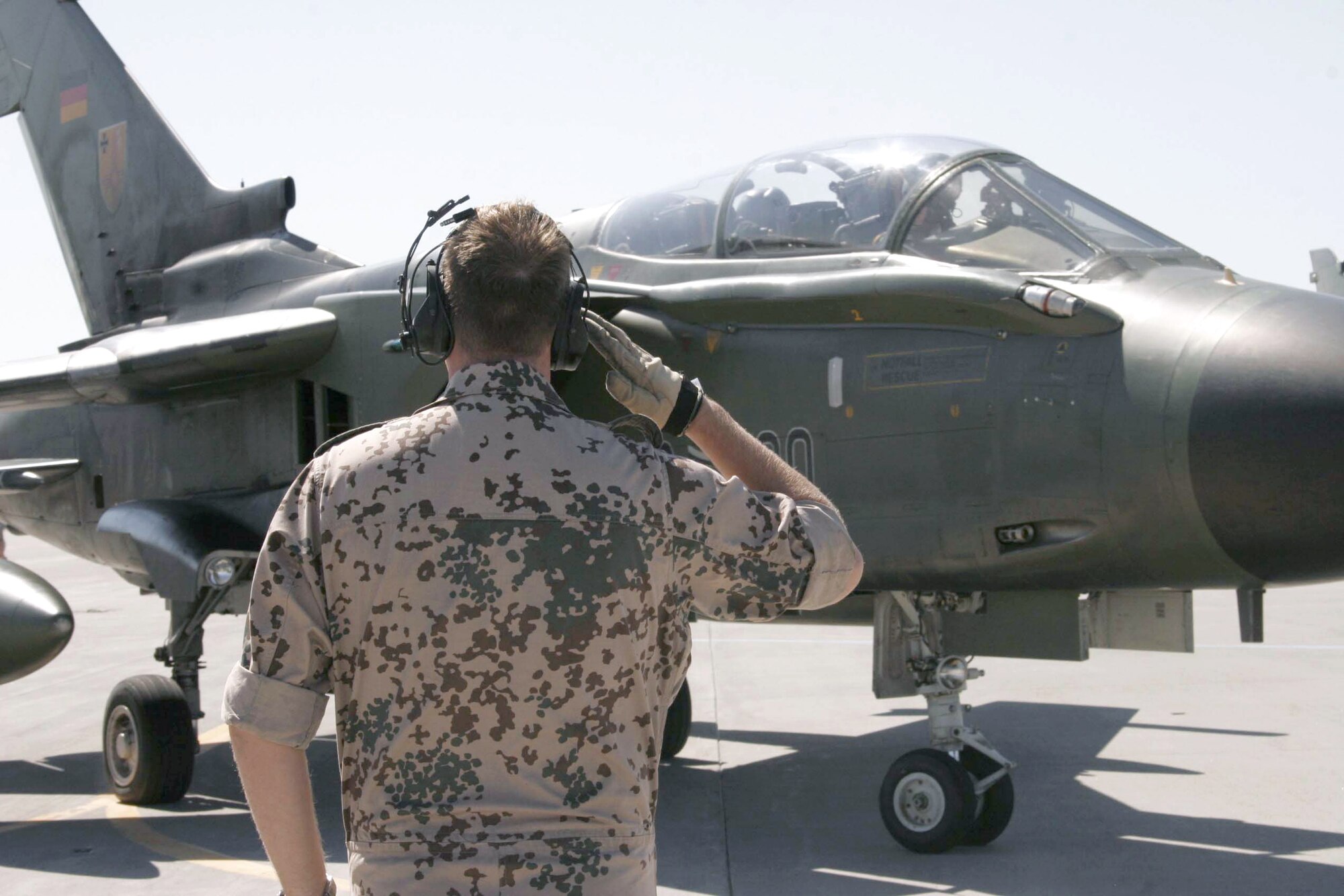 Tech. Sgt. Danny Behrens renders a salute after helping launch his Tornado interdiction strike aircraft for a training flight at Mountain Home Air Force Base, Idaho, on Wednesday, June 21. German air force aircrews and maintenance teams are working alongside their American counterparts during a joint training exercise. Sergeant Behrens is a crew chief with the German air force. (U.S. Air Force photo/Master Sgt. Brian S. Orban) 
