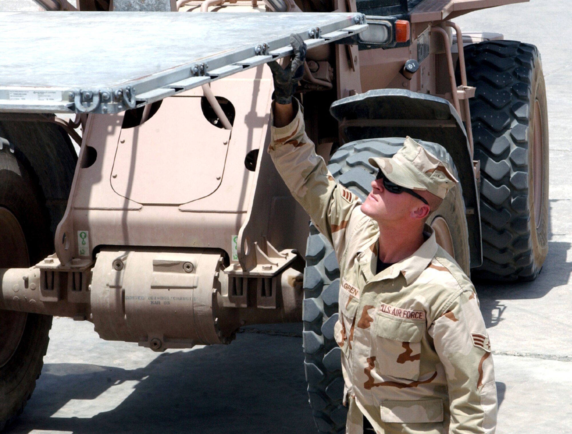 Senior Airman Randy Walgren checks a pallet for serviceability before stacking it for shipment at Ali Base, Iraq, on Wednesday, June 21. Airman Walgren and a team of 10 logisticians tracked down and returned to service more than $1 million of pallets in one month. (U.S. Air Force photo/Master Sgt. Andrew Gates) 

