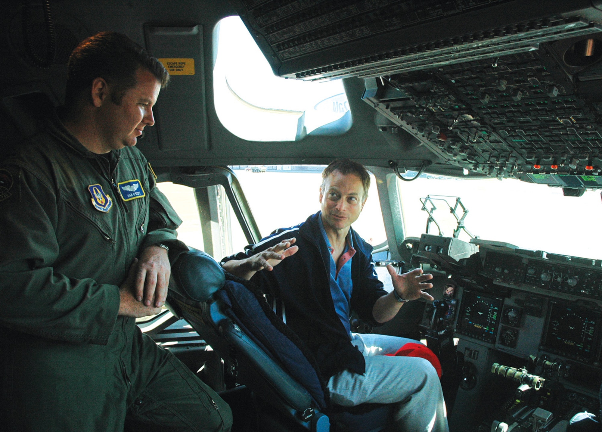 MCCHORD AIR FORCE BASE, Wash., - Actor Gary Sinise, known for his role as Lieutenant DanTaylor in the film "Forrest Gump," talks to 1st Lt. Dan OKeefe on a C-17 during his visit to McChord June 23. Mr. Sinise, currently staring in the television series "CSI: New York," was at McChord with his Lieutenant Dan Band, which often entertains troops throughout the world, concluding its fourth USO tour this month. Lieutenant OKeefe is a Reservist with the 313th Airlift Squadron here. (U.S. Air Force photo by Sandra Pishner)