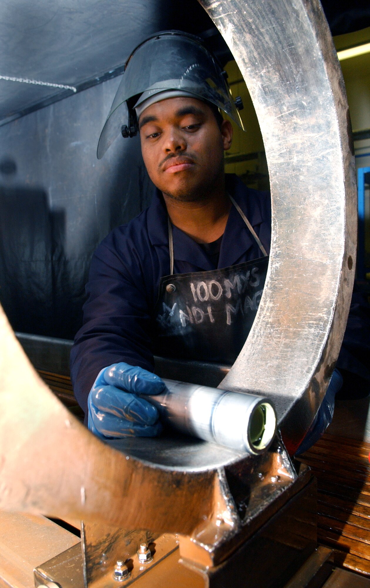 Airman Philip Liggins uses a magnetic coil to inspect an engine mount fuse pin at Royal Air Force Base Mildenhall, England, on Tuesday, June 20. Magnetic particle fluid is poured over aircraft parts; when it seeps into the cracks, it helps detect cracks and defects. Airman Liggins is a non-destructive inspection specialist with the 100th Maintenance Squadron. (U.S. Air Force photo/Staff Sgt. Tyrona Pearsall) 

