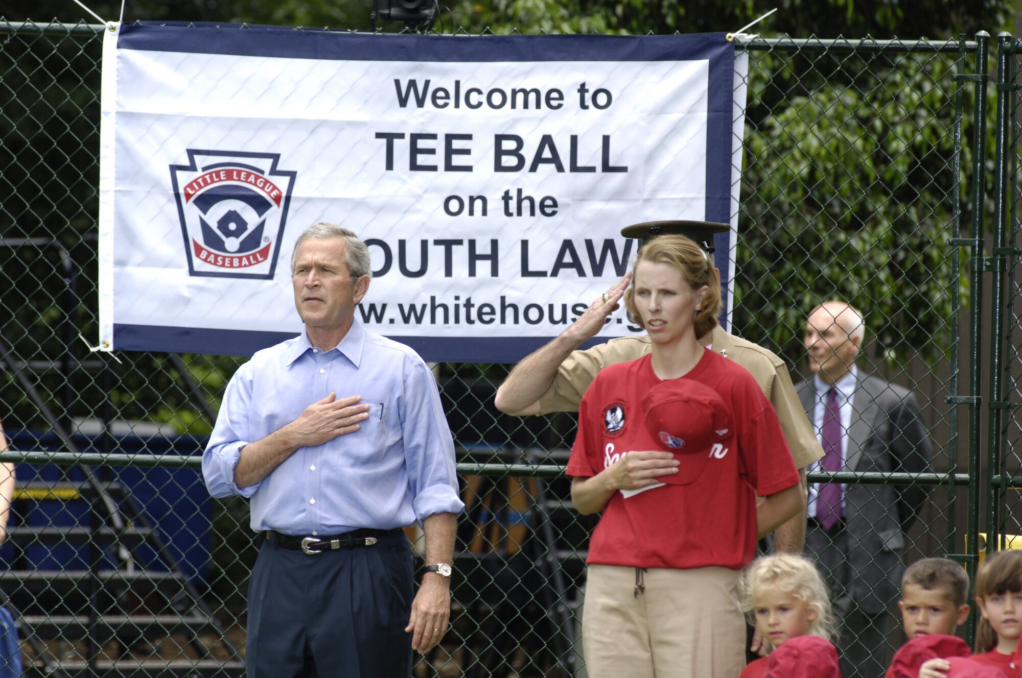 President George W. Bush and Danielle McPeak, McGuire Little League Yankees coach, pay respect to the National Anthem prior to the start of Tee Ball on the South Lawn June 23. 

Photo by:  Denise Gould