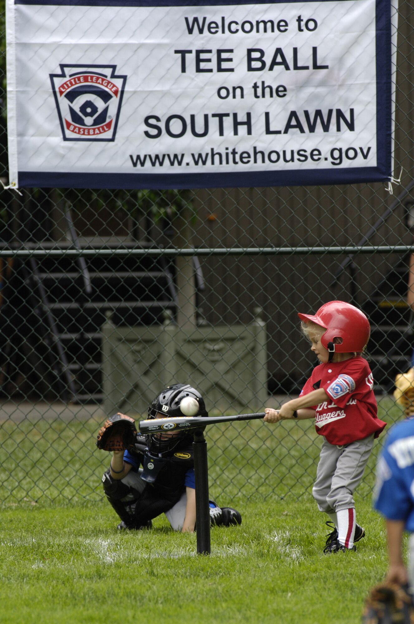 Carsyn Norway, McGuire Little League Yankees, hitter knocks a line drive during Tee Ball on the South Lawn June 23 at the White House. The McGuire Yankees faced off against the Dolcom Little League Indians from Naval Submarine Base New London in Groton, Conn. The teams were selected to represent the Air Force and Navy by Little League International for the one-inning game. Concluding the game, each player received an autographed baseball from the President George W. Bush. 

Photo by:  Denise Gould
