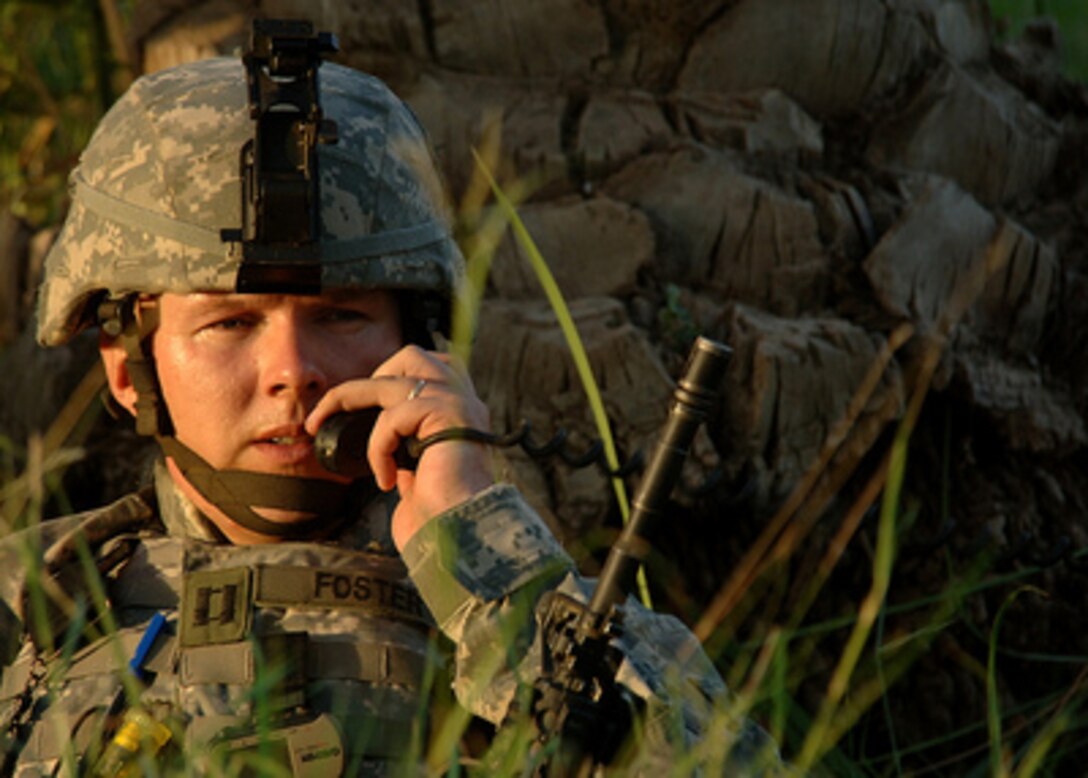 Army Capt. Chad Foster delivers a situation report over the radio during an air assault raid on a suspected insurgent sanctuary in Mushahda, Iraq, on June 23, 2006. Foster is from the 1st Battalion, 66th Armor Regiment, 1st Brigade Combat Team, 4th Infantry Division. 
