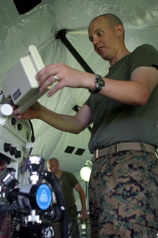 MARINE CORPS BASE CAMP LEJEUNE, N.C. (June 27, 2006) ?  Petty Officer 3rd Class Ronald J. Borgstrom fixes a monitor on a piece of lifesaving equipment. Sailors with Bravo Surgical Co., 2nd Medical Battalion, 2nd Marine Logistics Group, set up a mock Surgical/Shock Trauma Platoon setup. What makes the SSTP so efficient in a combat zone is its portability and effectiveness. Borgstrom is a surgical technician with the company.