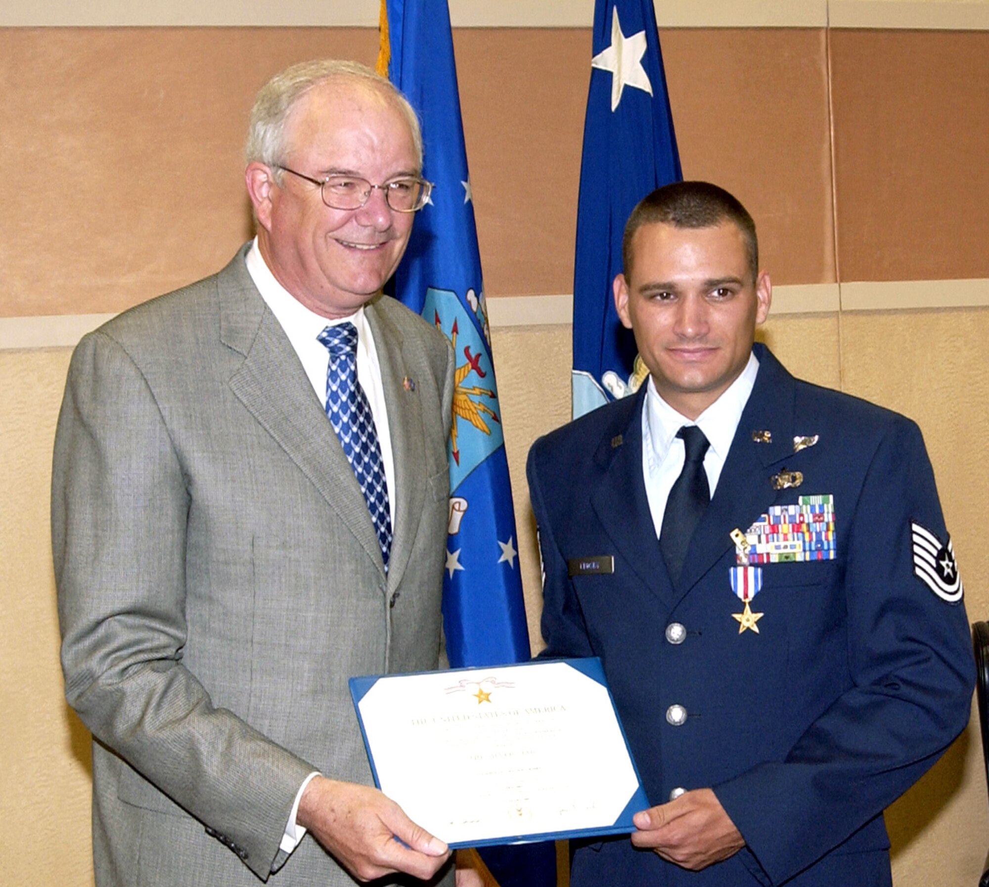 Secretary of the Air Force Michael Wynne presents Tech. Sgt. Travis Crosby with the Silver Star during a ceremony on Monday, June 26, at Pope Air Force Base, N.C., for heroic actions while deployed in support of Operation Iraqi Freedom in 2003. Sergeant Crosby is a member of a tactical air control party with the 15th Air Support Operations Squadron. (U.S. Air Force photo/Dave Davenport)