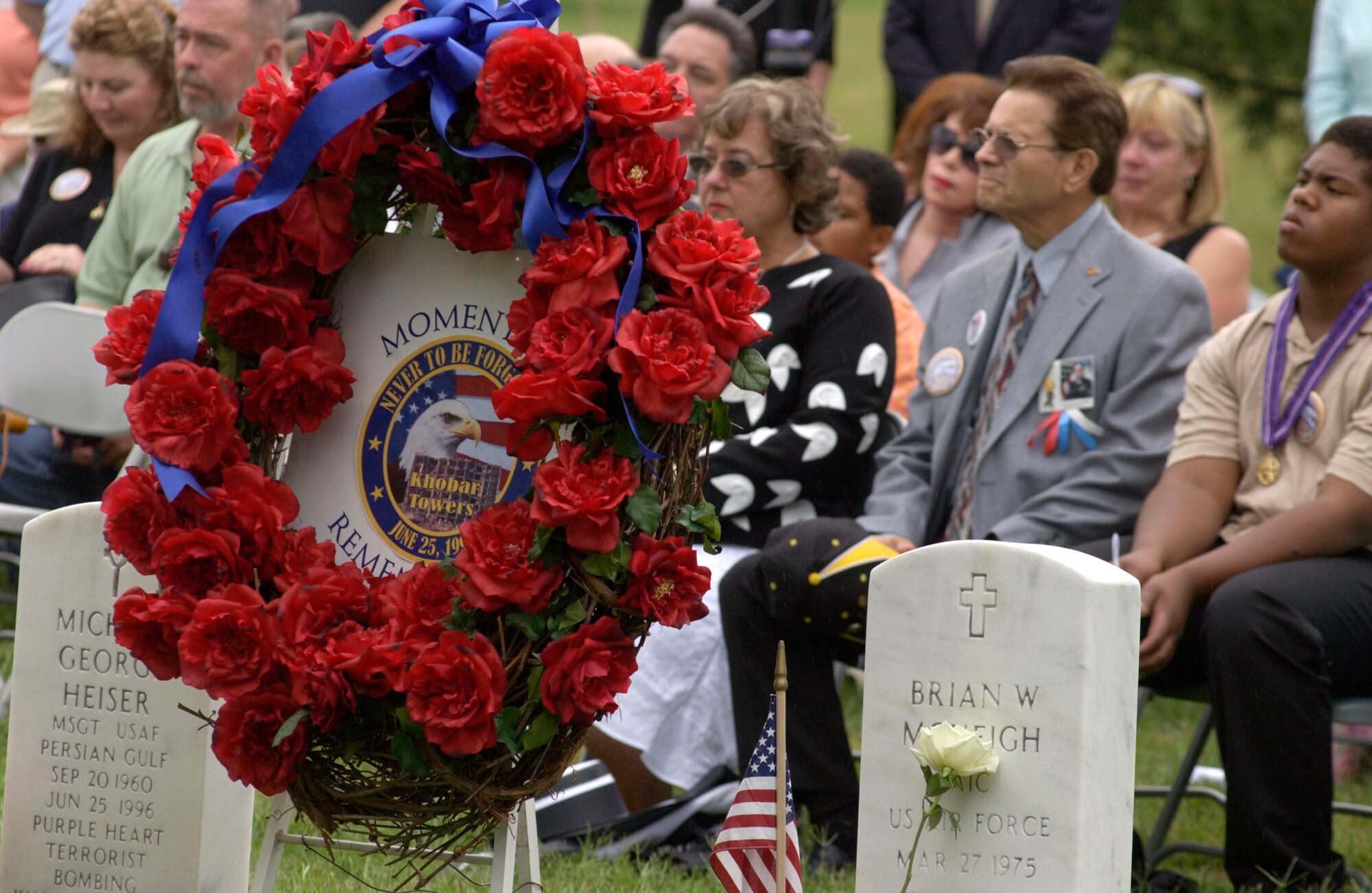 A wreath stands between the headstones of Master Sgt. Michael George Heiser and Airman 1st Class Brian W. McVeigh during the remembrance ceremony for the Khobar Towers bombing on Sunday, June 25, at Arlington National Cemetery, Va. The two were among 19 Airmen killed on June 25, 1996, in the terrorist bombing at Dhahran Air Base, Saudi Arabia.  Family members and friends of the Airmen killed in the terrorist bombing gathered for the ceremony.   (U.S. Air Force photo/Tech. Sgt. Cohen A. Young) 