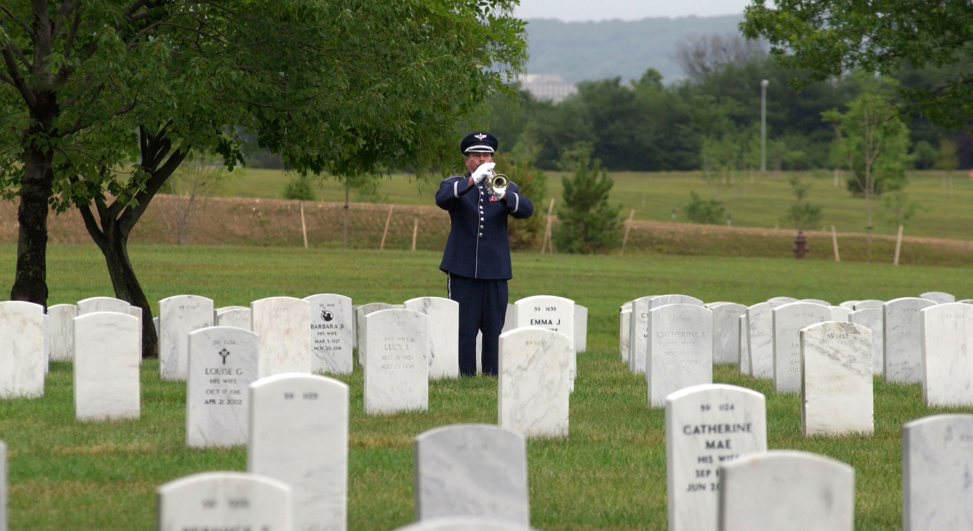 Master Sgt. Robert Connolly plays "Taps" during the remembrance ceremony for the Khobar Towers bombing on Sunday, June 25, at Arlington National Cemetery, Va. Family members and friends of the 19 Airmen killed in the terrorist bombing at Dhahran Air Base, Saudi Arabia, on June 25, 1996, gathered for the ceremony. Sergeant Connolly is a member of the Air Force Band at Bolling Air Force Base, D.C.  (U.S. Air Force photo/Tech. Sgt. Cohen A. Young)