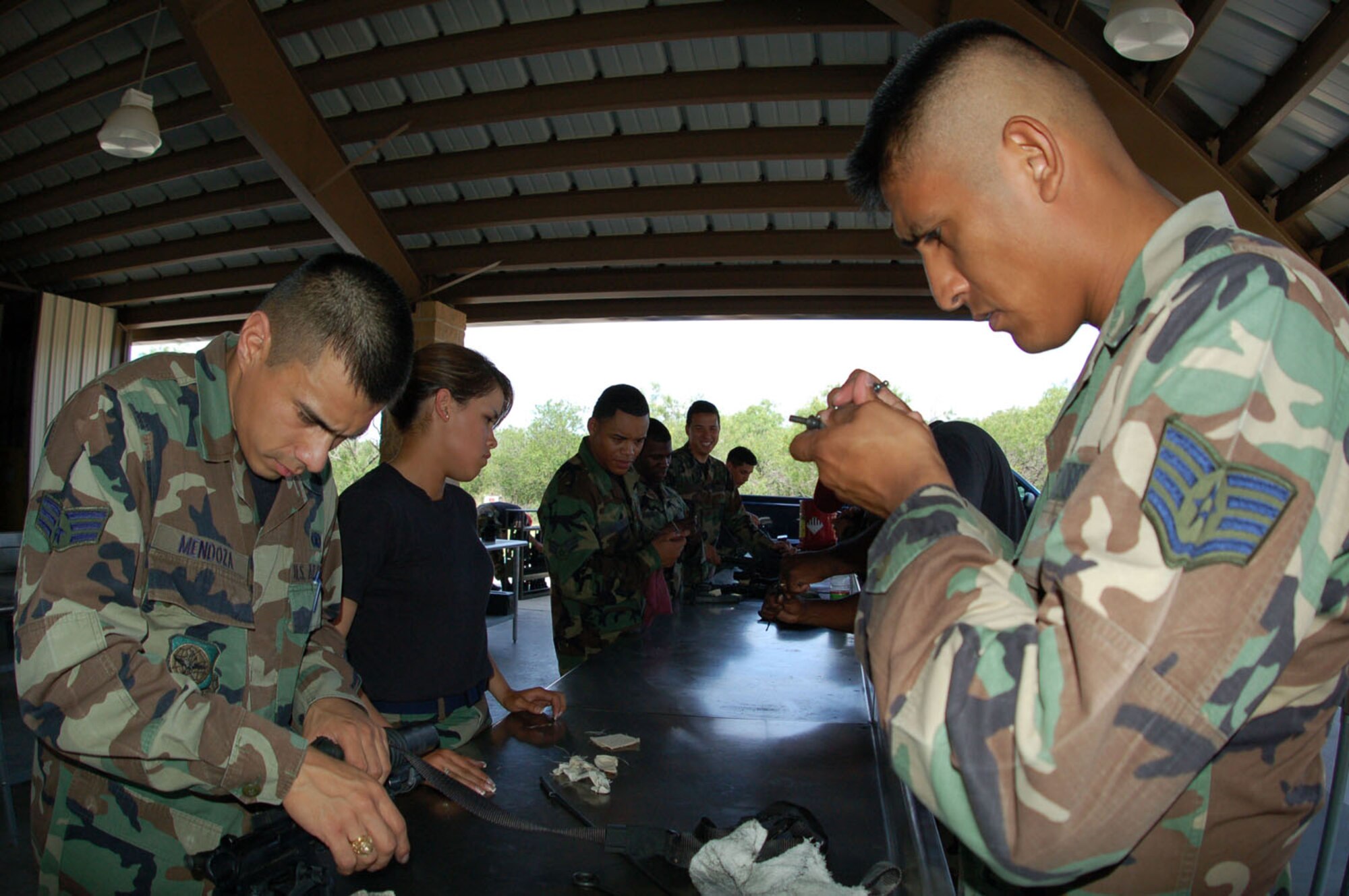 Staff Sgt. Manuel Camacho, a small arms instructor with the 433rd Security Forces Squadron inspects a weapon after a qualifications course. Sergeant Camacho was one of two Alamo Wing members to participate in the Strickland competition in England. The team took second over all and placed first in the shooting competition. Sergeant Camacho participated last year also and will soon move to accept an active Guard and Reserve tour with the 610th Security Forces Squadron who hosts the competition team annually. (U.S. Air Force Photo/Tech Sgt. Collen McGee)