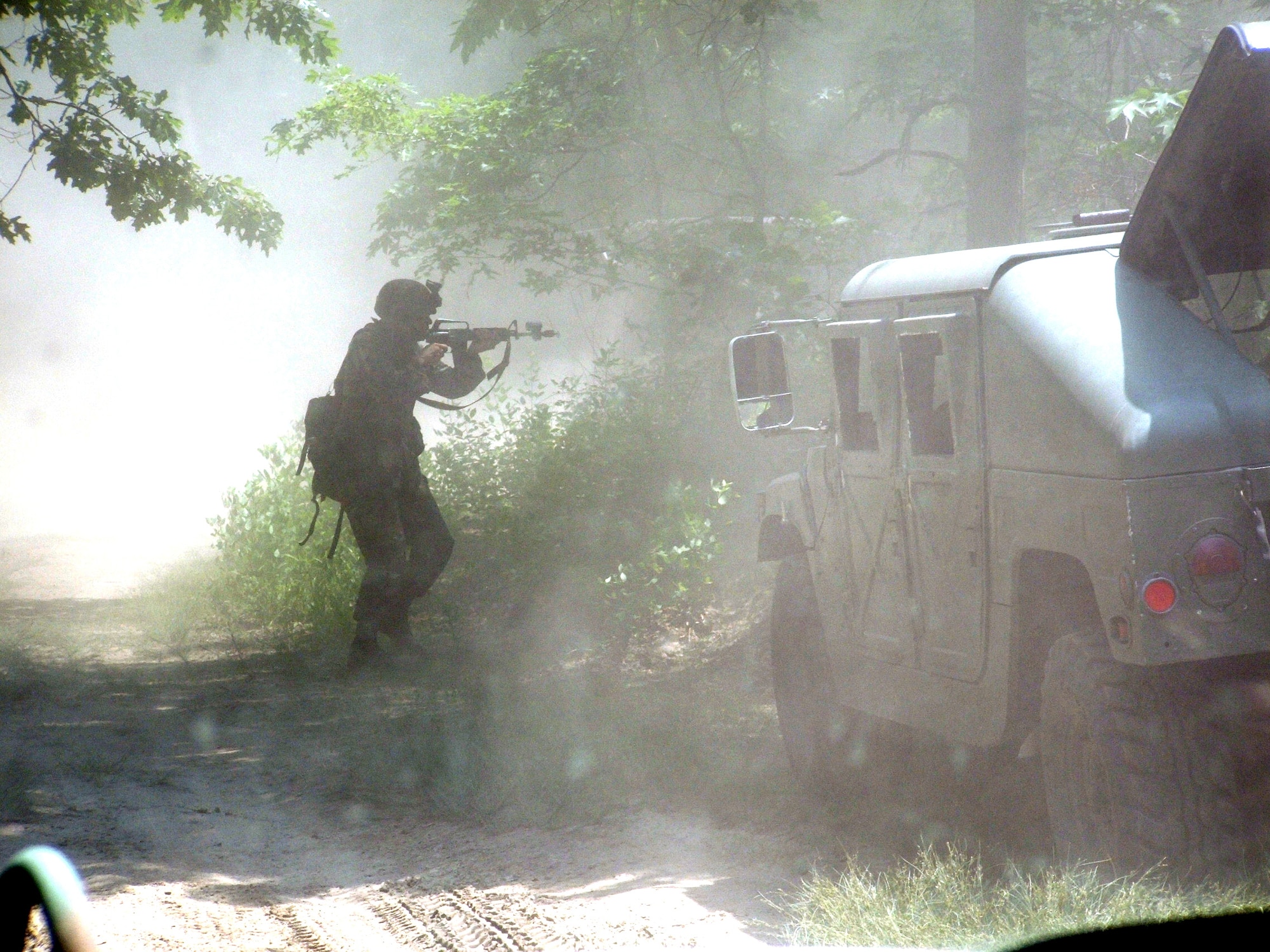 An Airman simulates manning a checkpoint while engaging enemy fire during convoy training on Thursday, June 22, as part of the Integrated Contingency Skills Training Course 06-4 at Fort Dix, N.J. More than 165 students are participating in the course. The training is taught by staff at the Air Mobility Warfare Center's 421st Combat Training Squadron. (U.S. Air Force photo/Tech. Sgt. Scott T. Sturkol)
