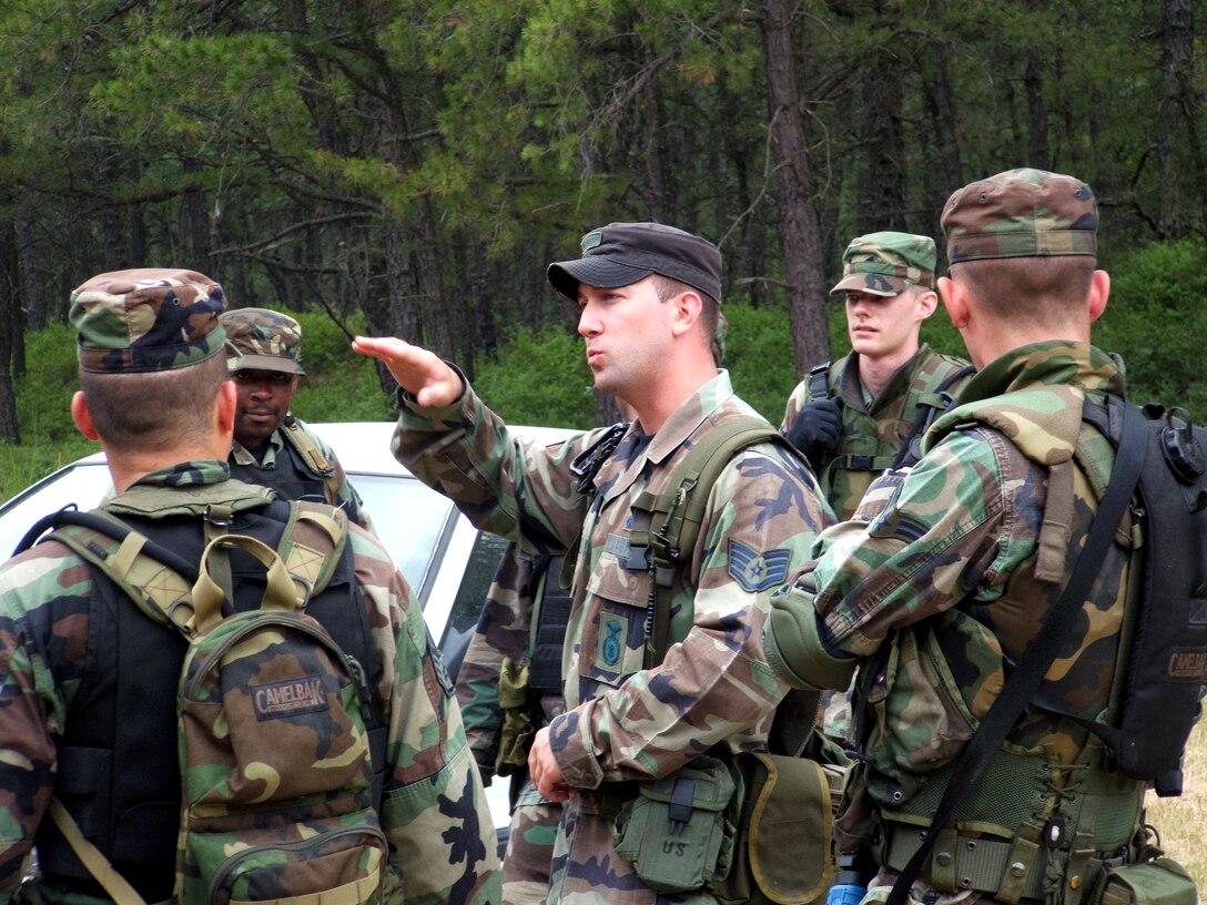 Staff Sgt. Jason Venturella (center) briefs Airmen on urban tactics during the Integrated Contingency Skills Training Course 06-4 at Naval Air Engineering Station Lakehurst, N.J., on Thursday, June 22. More than 165 students are participating in the course. Students also learn convoy training in preparation for deployments. The training is taught by staff at the Air Mobility Warfare Center's 421st Combat Training Squadron. (U.S. Air Force photo/Tech. Sgt. Scott T. Sturkol)